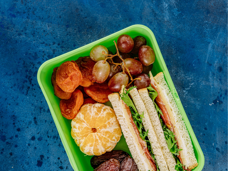 A Sandwich Lunch Box with Fruits